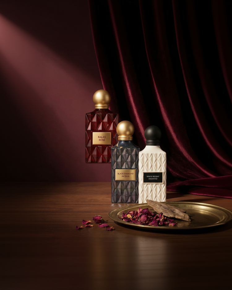 Three perfume bottles on a wooden surface with a red curtain background